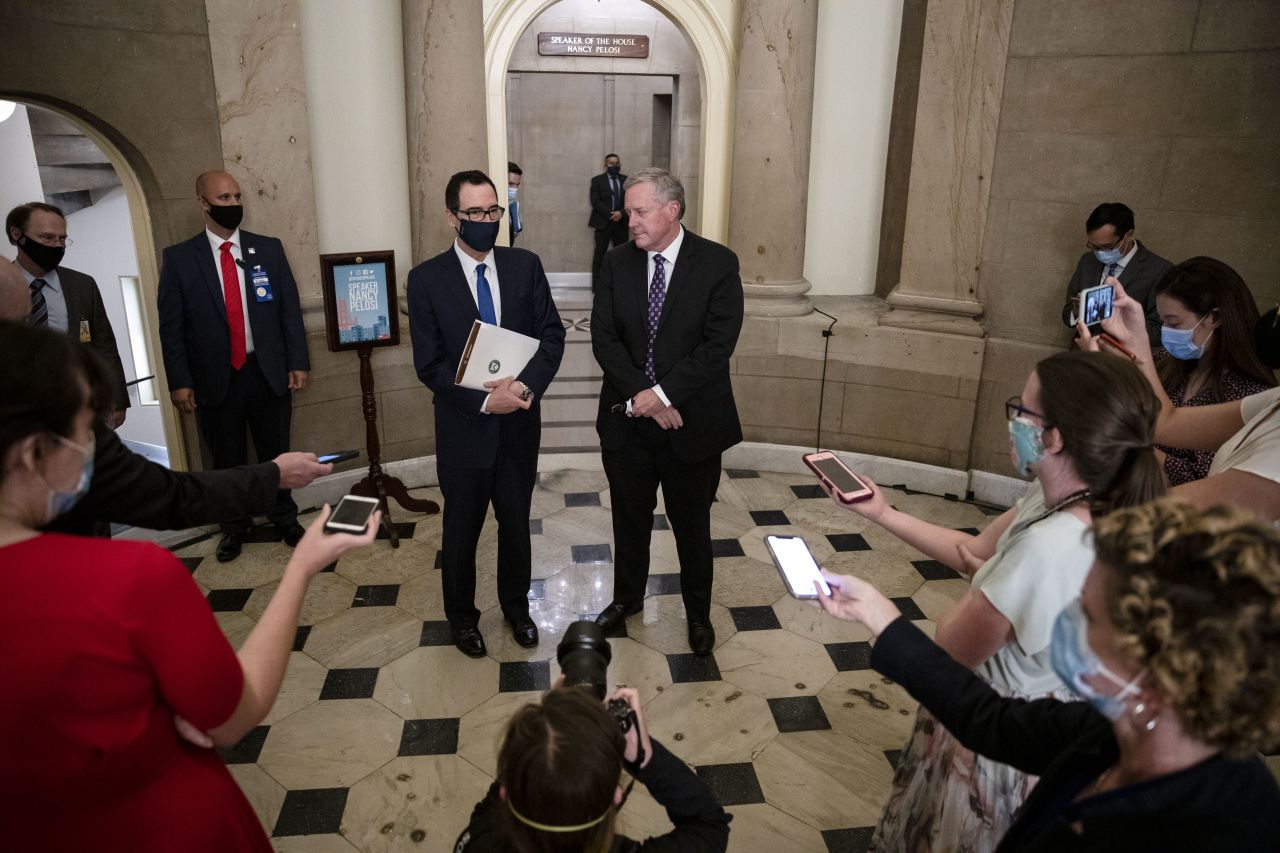 Treasury Secretary Steven Mnuchin and White House chief of staff Mark Meadows — center left and right, respectively — speak to reporters on July 30 in Washington, DC, after a meeting with Speaker Nancy Pelosi and Senate Democratic Leader Chuck Schumer.