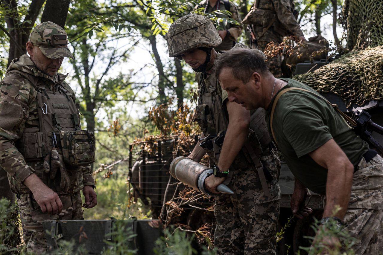 Ukrainian soldiers transport shells into a camouflaged tank on the Bakhmut frontline in the Donetsk region of Ukraine on Monday.