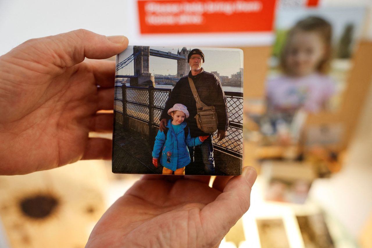 Thomas Hand, the father of Emily Hand, holds up a picture of them together at his hotel near the Dead Sea in Israel on November 10.