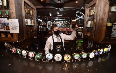 A barman in Murrays pub on Grafton street checks the head on a pint of Guinness on June 29 in Dublin, Ireland. 