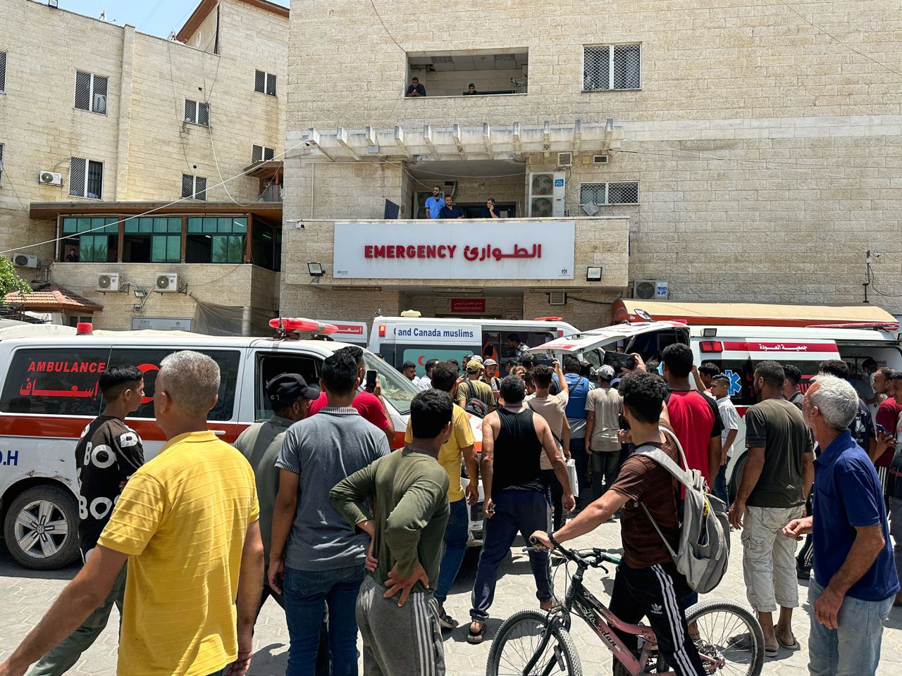 People gather outside Al-Aqsa Martyrs Hospital in Deir al-Balah, Gaza, on June 8. 