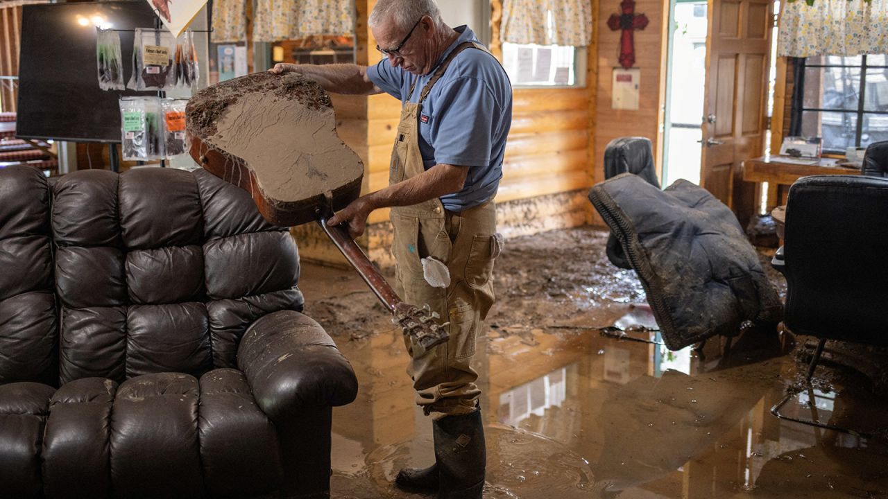 Bobby Smith, the property manager of the River Ranch RV Park, empties water out of a guitar after the property was damaged from a flash flood in the aftermath of the fires in Ruidoso Downs, New Mexico, on June 20. 