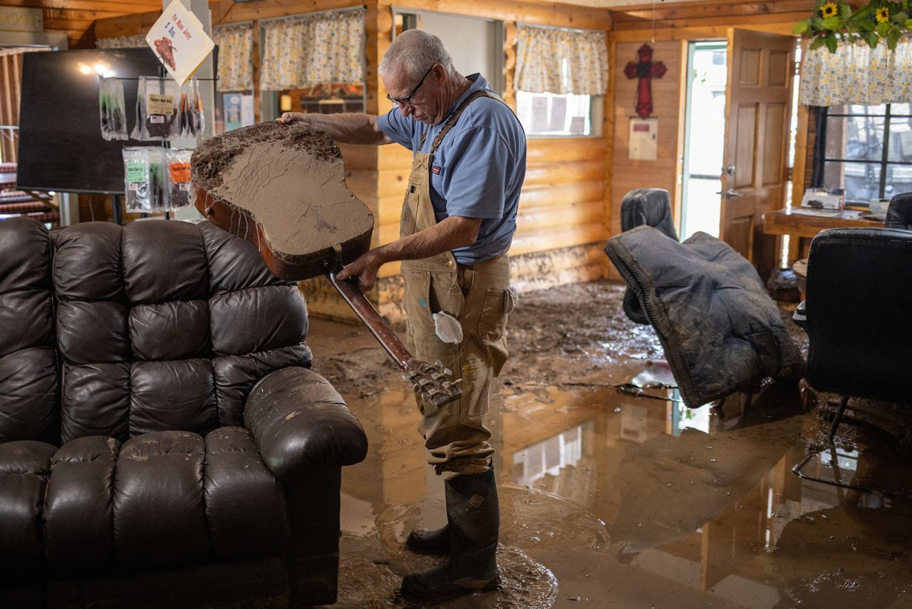 Bobby Smith, the property manager of the River Ranch RV Park, empties water out of a guitar after the property was damaged from a flash flood in the aftermath of the fires in Ruidoso Downs, New Mexico, on June 20. 