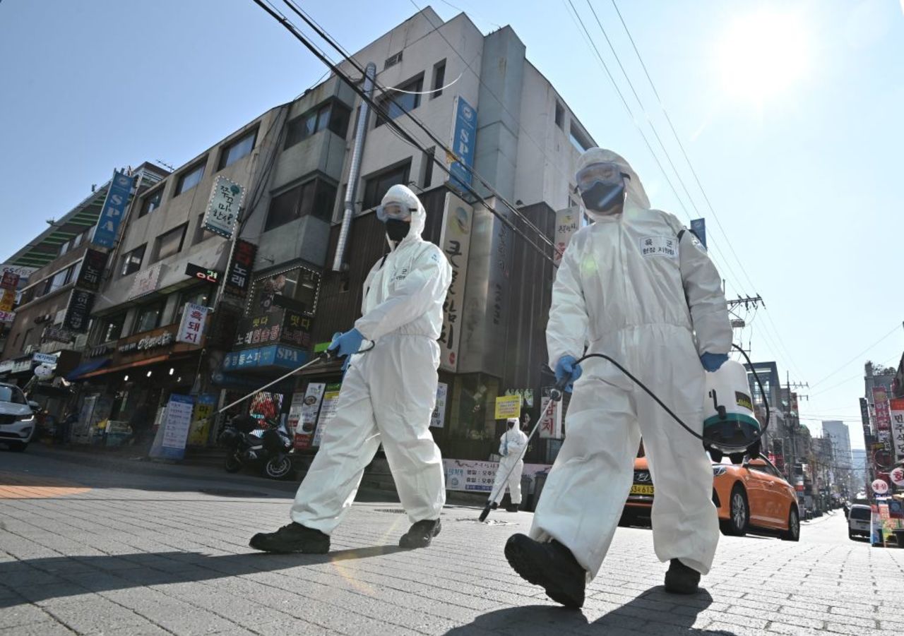 South Korean soldiers spray disinfectant on the street in Seoul on Wednesday.