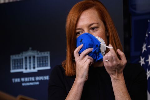 White House Press Secretary Jen Psaki removes two masks as she arrives for a press briefing at the White House on January 22.