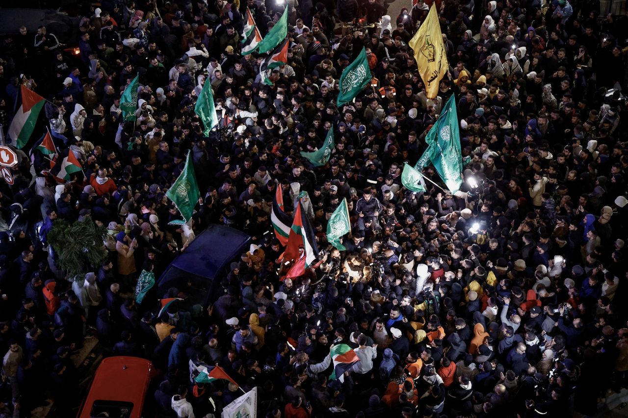 Palestinian prisoners, center, are cheered by a crowd of supporters in Ramallah, following their release from Israeli jails, on November 26. 