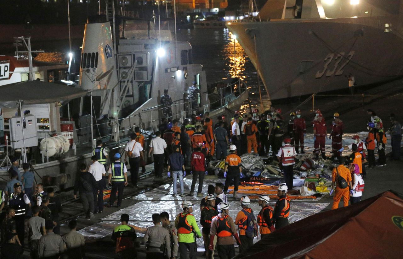 Rescuers wait for the arrival of an Indonesian Navy ship carrying debris recovered from the area where a Lion Air passenger jet is suspected to have crashed.