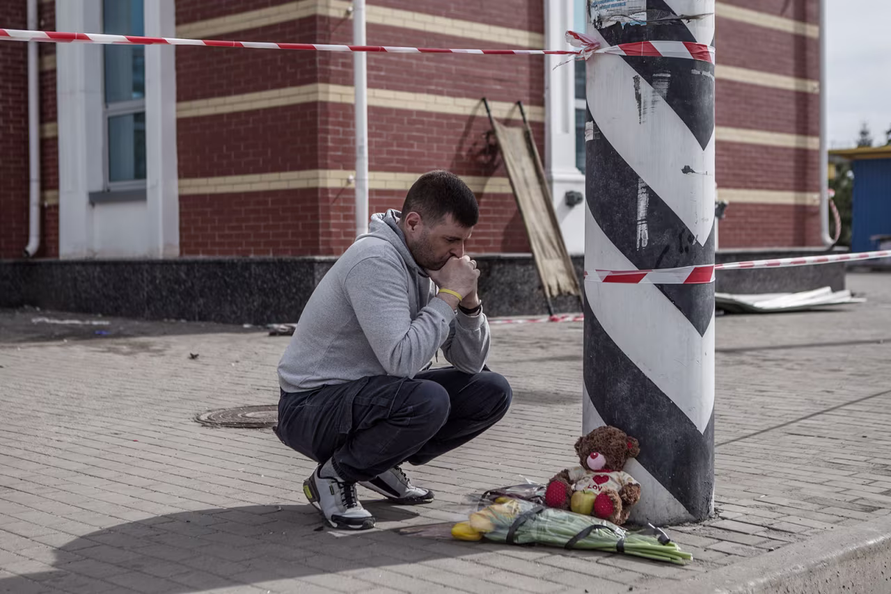 A man lays flowers at the Kramatorsk railway station after the Russian missile strike in Kramatorsk, Ukraine, on April 9. 