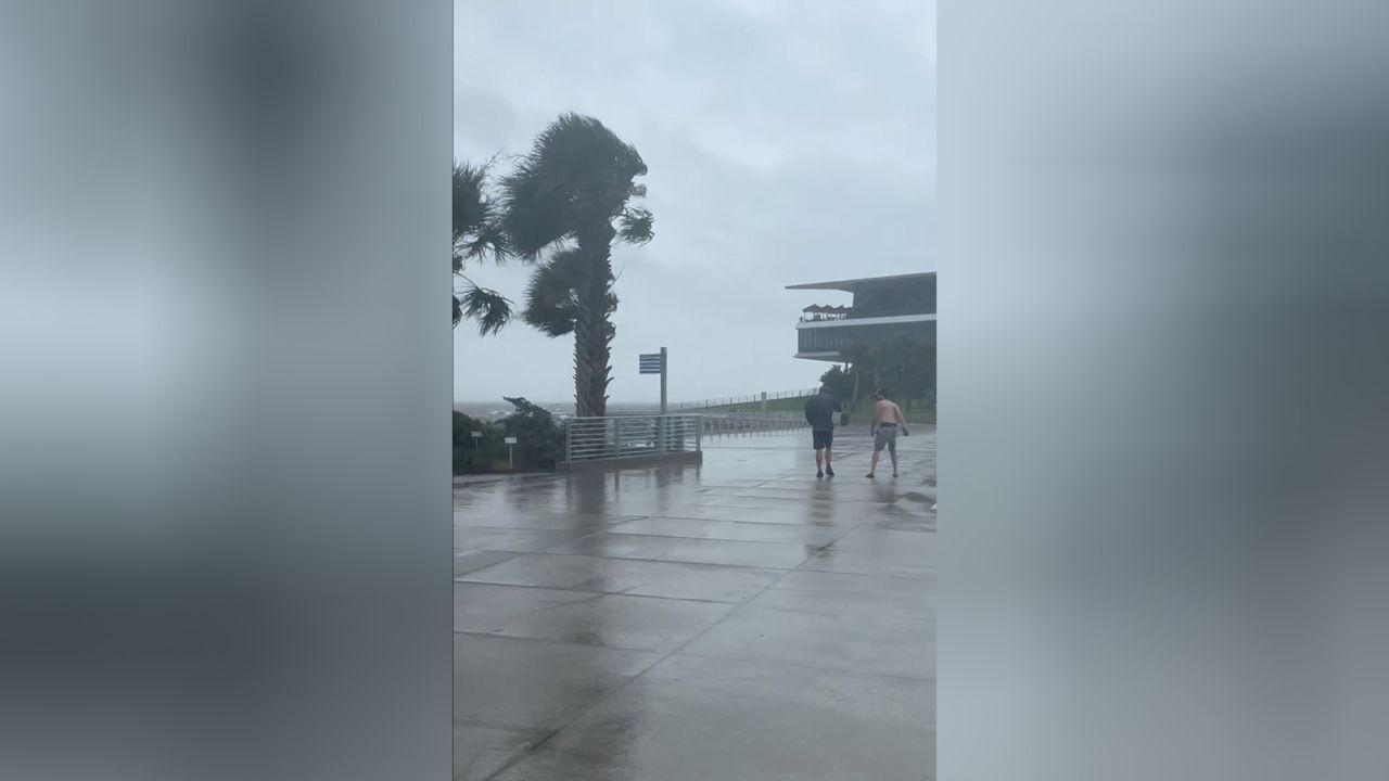 Men walk amid strong winds as Tropical Storm Debby approaches, in St. Petersburg, Florida, U.S. on August 4.