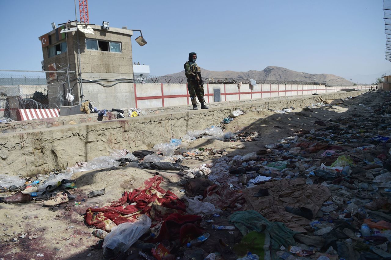 A Taliban fighter stands guard at the site of the August 26 suicide bombs on August 27.