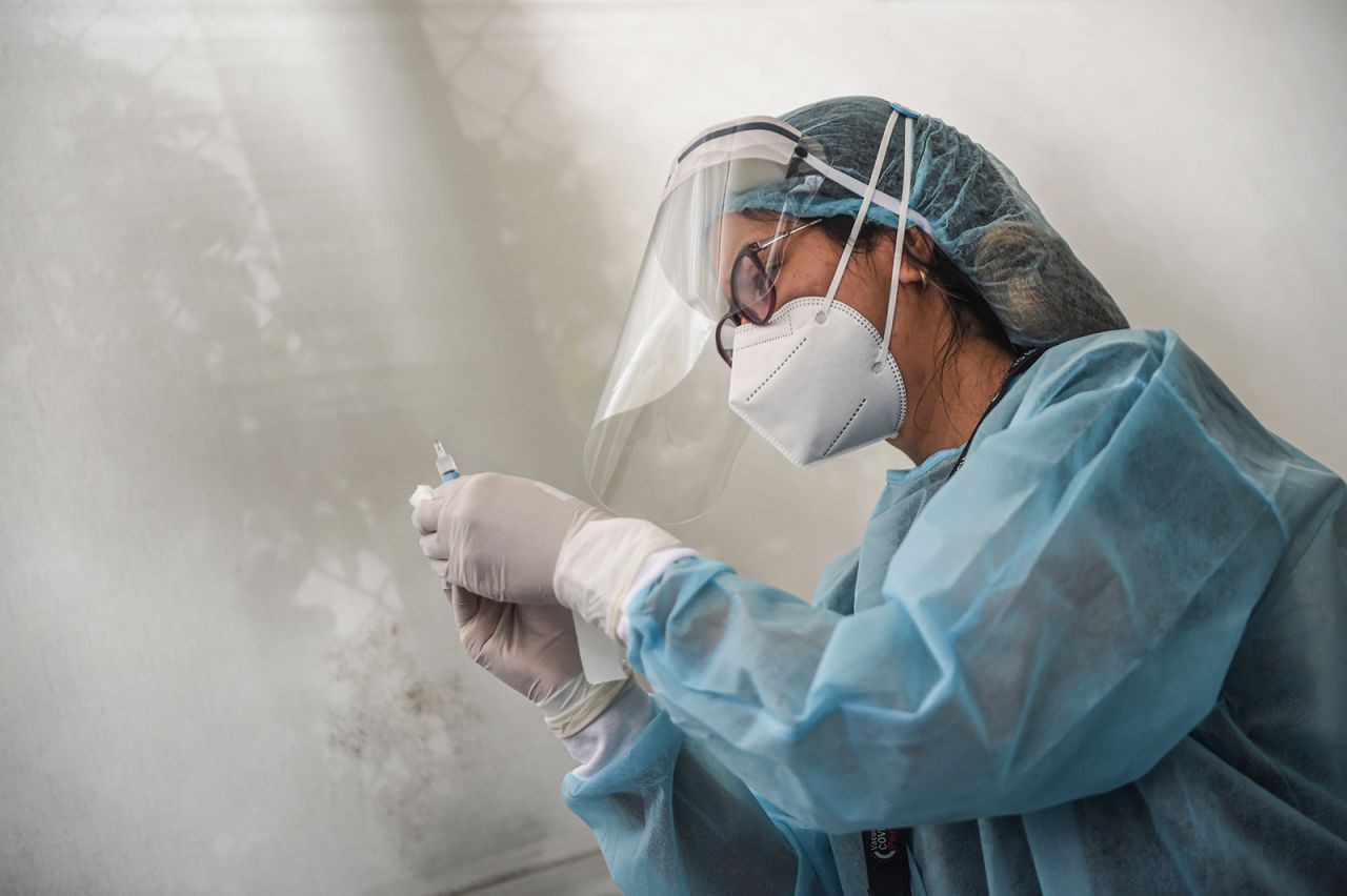 A health worker prepares a syringe to inoculate a volunteer with a Covid-19 vaccine produced by Sinopharm during its trial at the Clinical Studies Center of the Cayetano Heredia University in Lima, Peru, on Dec. 9.