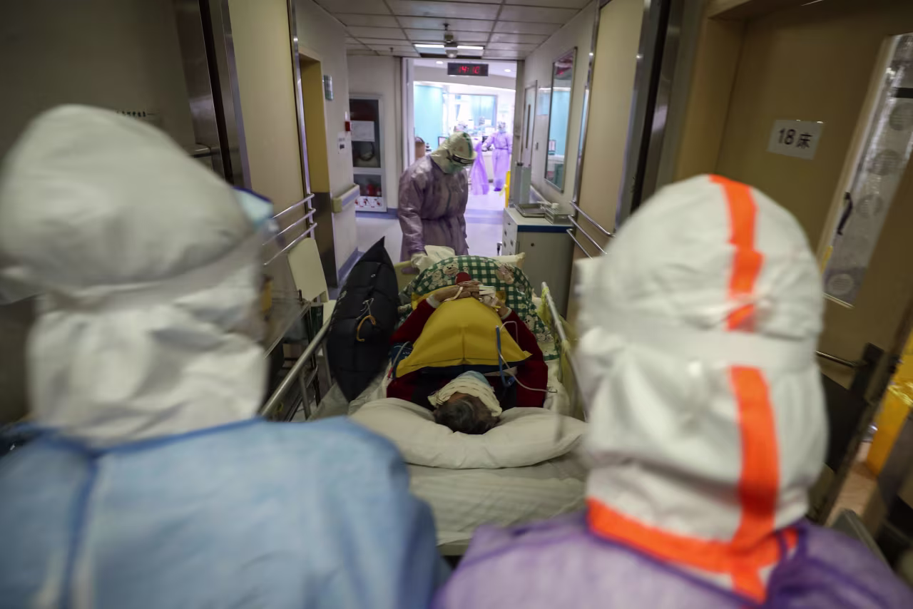 Medical staff at the Red Cross hospital in Wuhan transfer a coronavirus patient on February 28. 