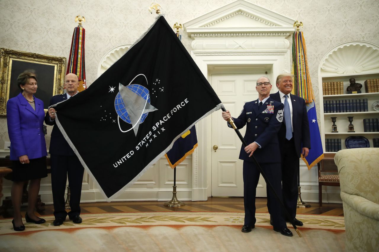 Donald Trump stands is seen with the United States Space Force flag as it is presented at the White House in 2020.