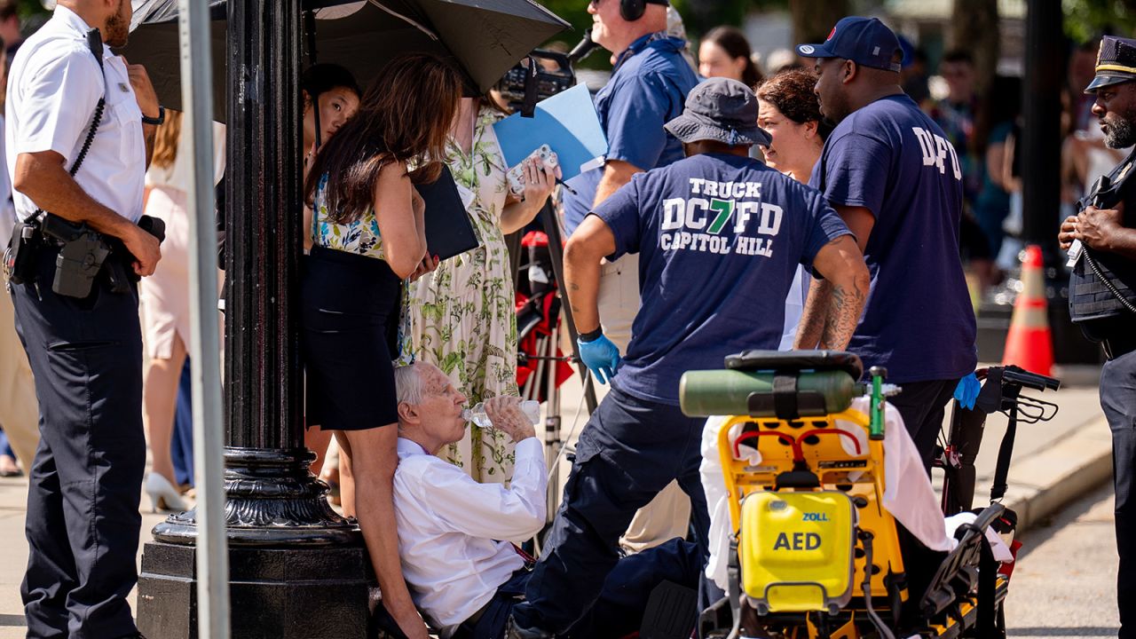 A man is attended to after fainting in the heat outside the Supreme Court in Washington, DC on June 20. 