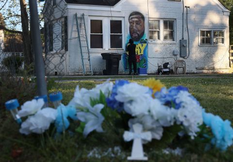 Ulysses Edwards paints a portrait of Andrew Brown Jr. on the side of a house near where he was killed in Elizabeth City, North Carolina.
