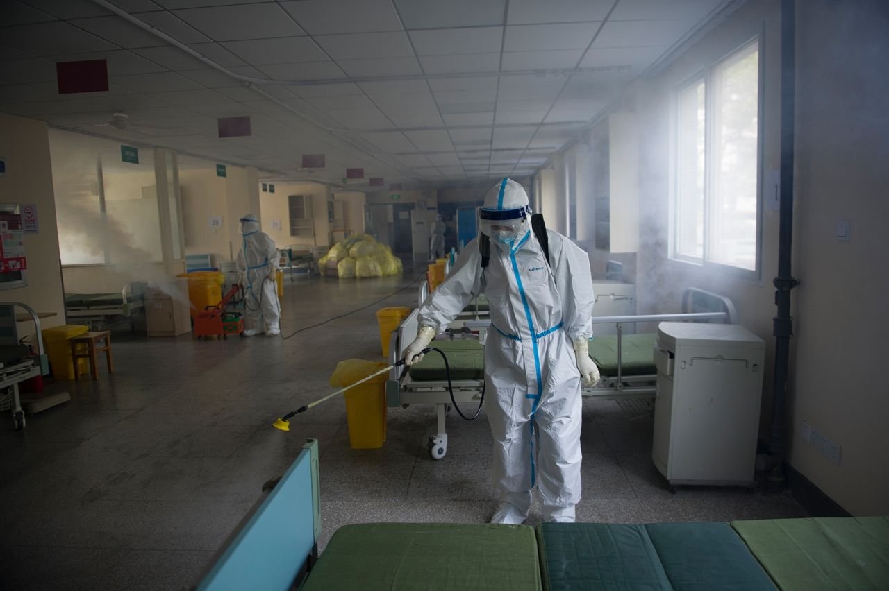 A worker disinfects around the No. 7 Hospital, once designated for only coronavirus patients, in Wuhan in central China's Hubei province on Thursday, March 19. The hospital is getting back to be a normal hospital after the last coronavirus patient was transferred away.