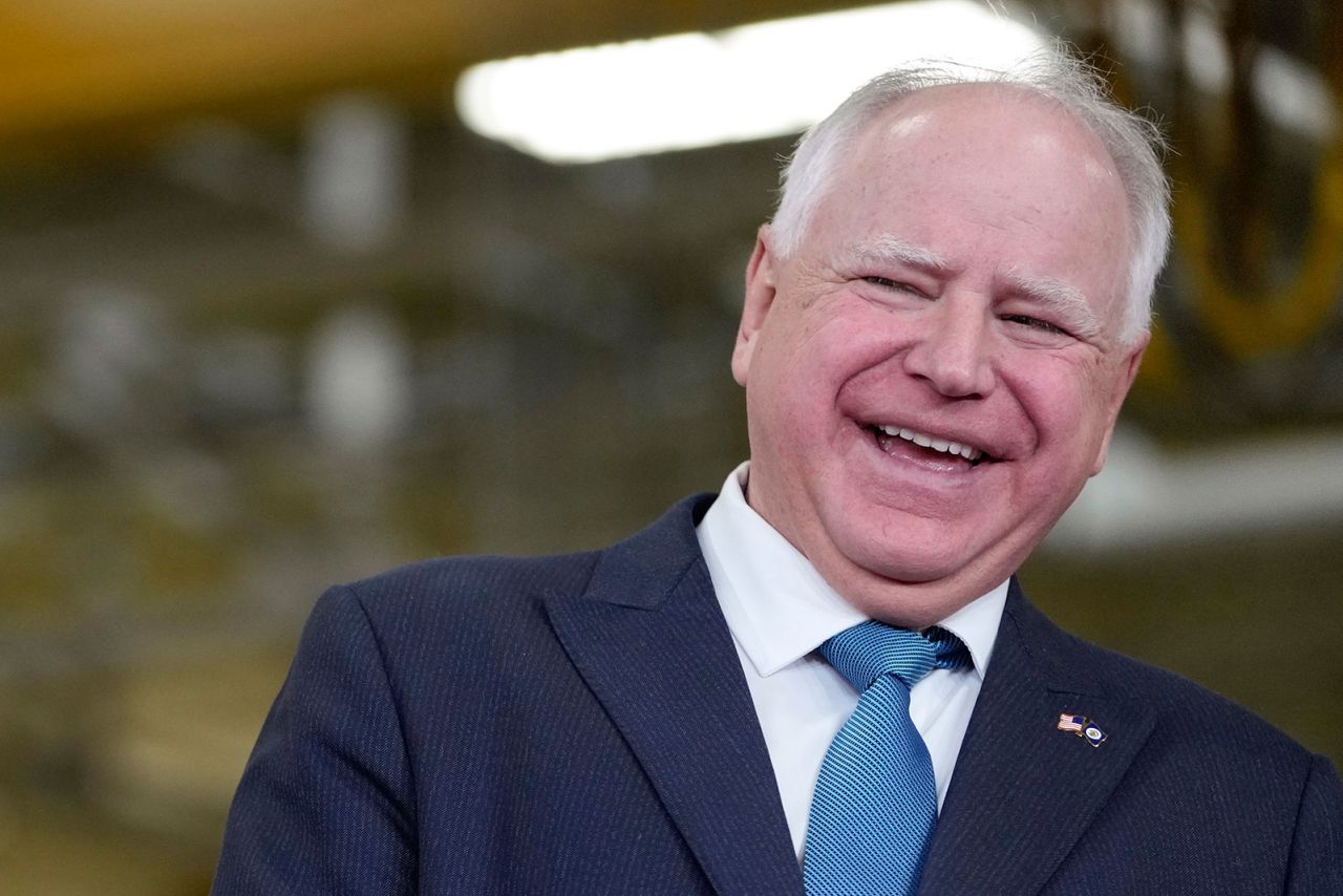 Minnesota Gov. Tim Walz laughs as during a visit to the Cummins Power Generation Facility in Fridley, Minnesota, on Monday, April 3, 2023. 