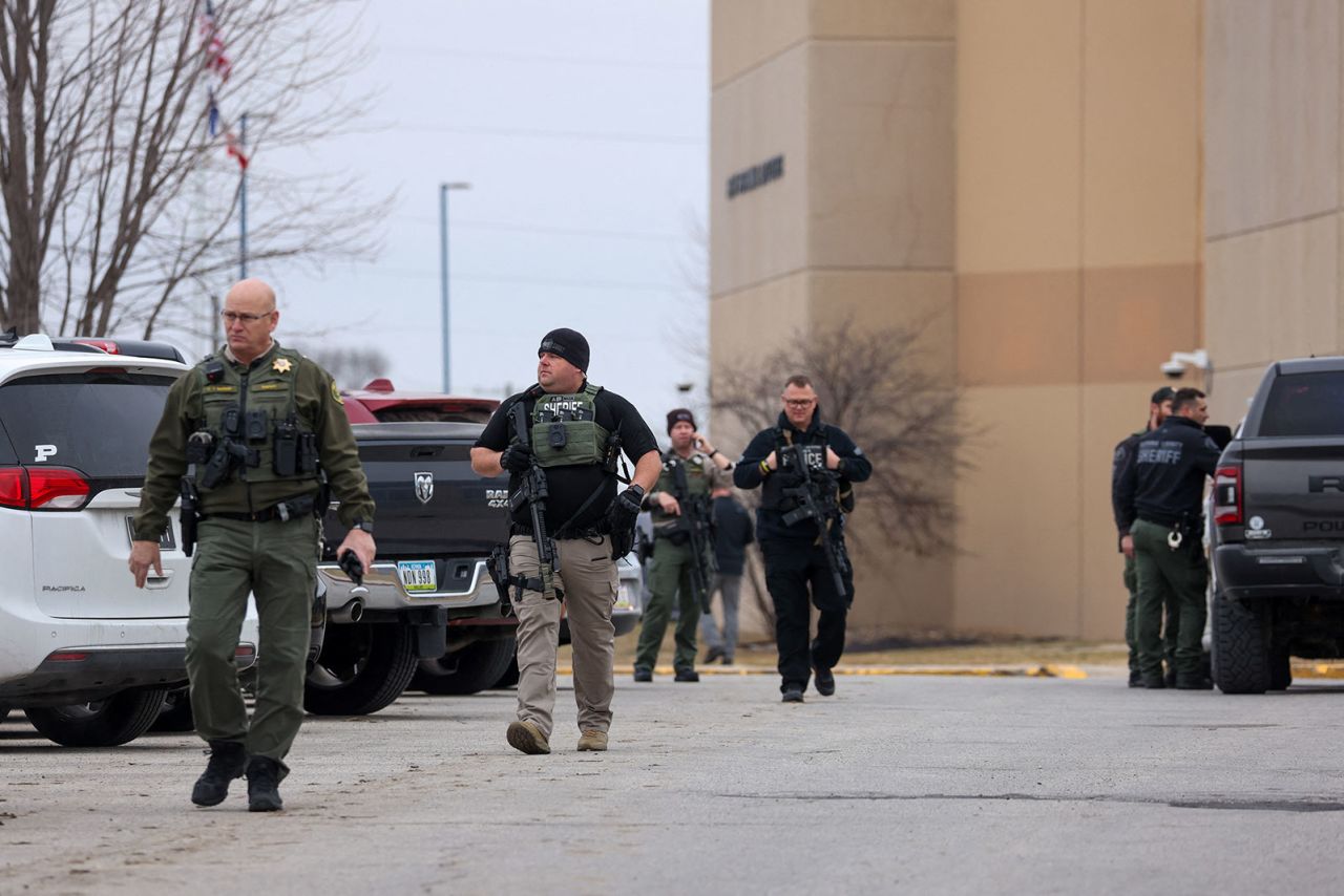 Law enforcement officers work at the scene of a shooting at Perry High School in Perry, Iowa, on Thursday.