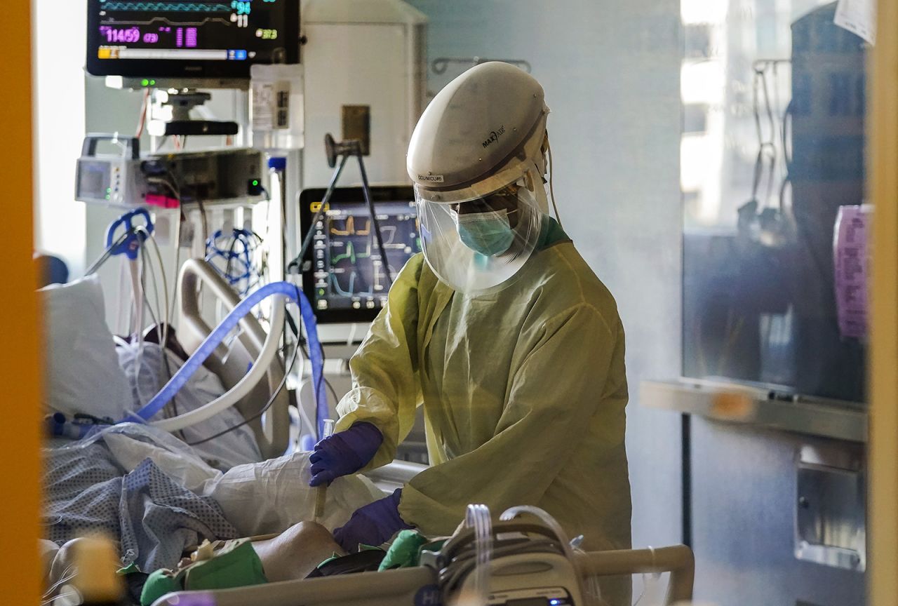 In this Wednesday, Jan. 13, 2021 file photo, a health care worker tends to a Covid-19 patient in the intensive care unit at Santa Clara Valley Medical Center during the coronavirus pandemic in San Jose, California. 