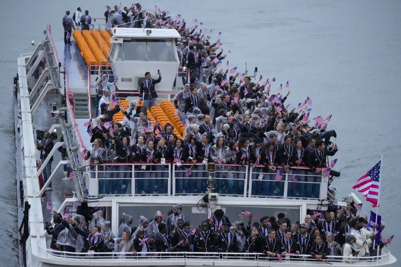 Athletes from the United States travel down the Seine River in Paris during the Olympics opening ceremony.