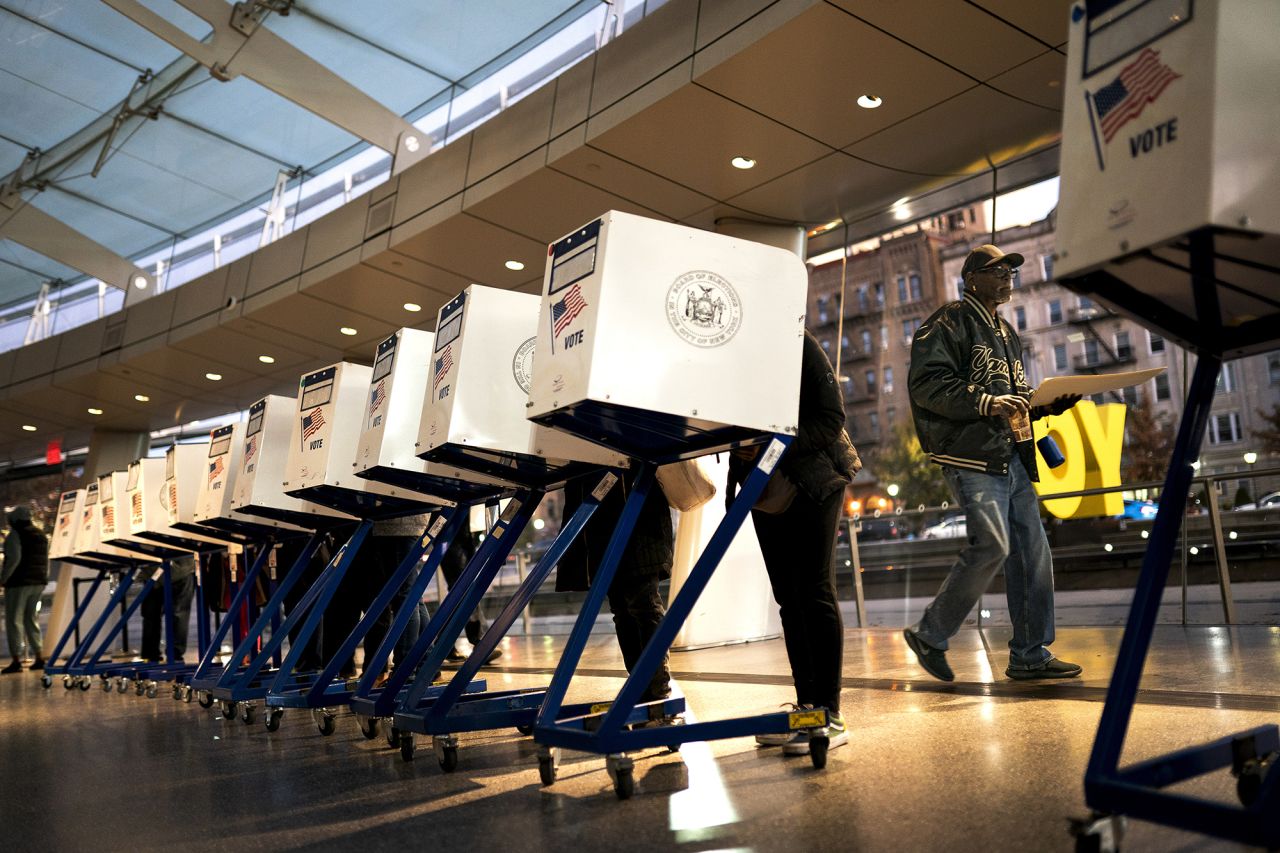 The first voters of the day begin filling out their ballots at a polling site in the Brooklyn Museum as the doors open for the midterm election on Tuesday in New York. 