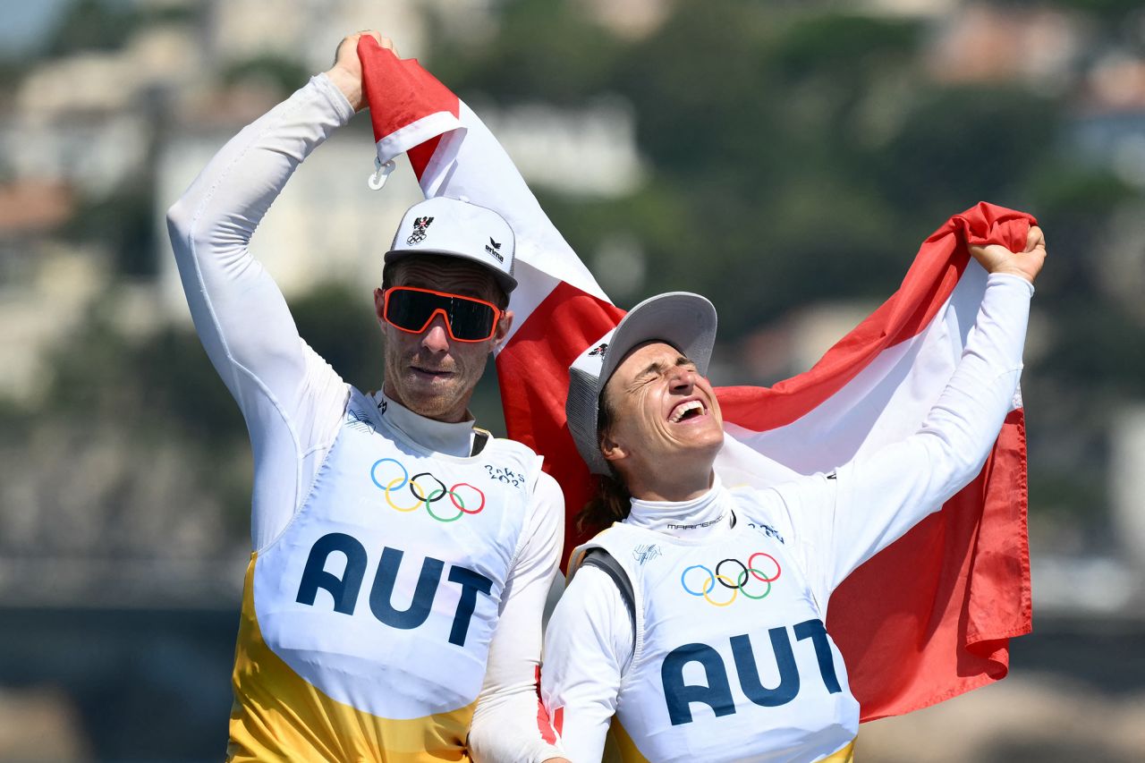 Gold medallists Austria's Lara Vadlau and Lukas Maehr celebrate after the medal race of the mixed 470 double-handed dinghy event during the Paris 2024 Olympic Games sailing competition at the Roucas-Blanc Marina in Marseille on August 8.