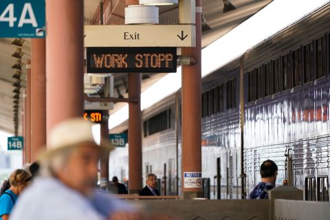People wait on an Amtrak train platform at Union Station in Los Angeles as stoppages are announced on September 14.