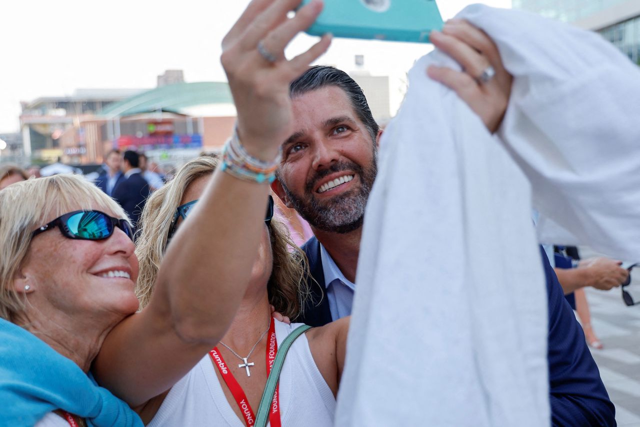 Donald Trump Jr. mingles with attendees as he arrives at the debate hall on Wednesday.