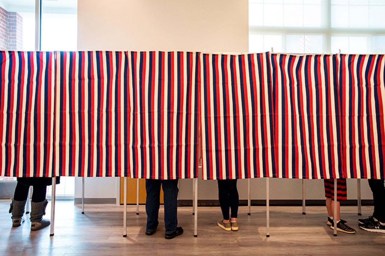 Voters fill in their ballots at polling booths for the presidential election in Concord, New Hampshire, on November 3, 2020.?