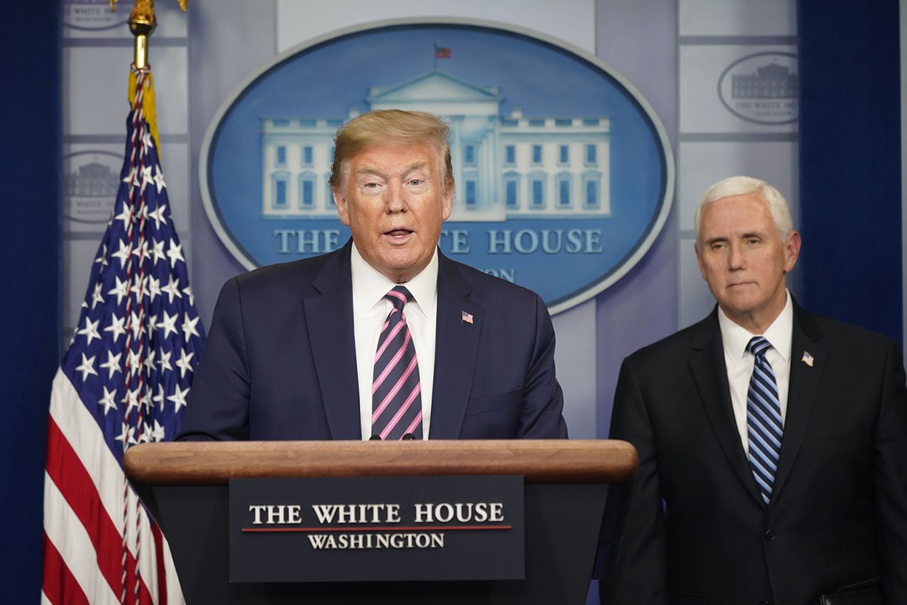 President Donald Trump speaks as Vice President Mike Pence listens during a news conference in the White House on April 24. 
