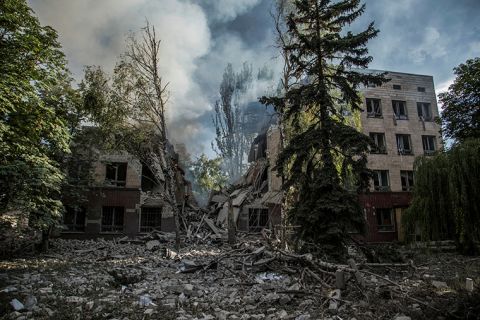 Smoke rises over the remains of a building destroyed by a military strike in Lysychansk on June 17.