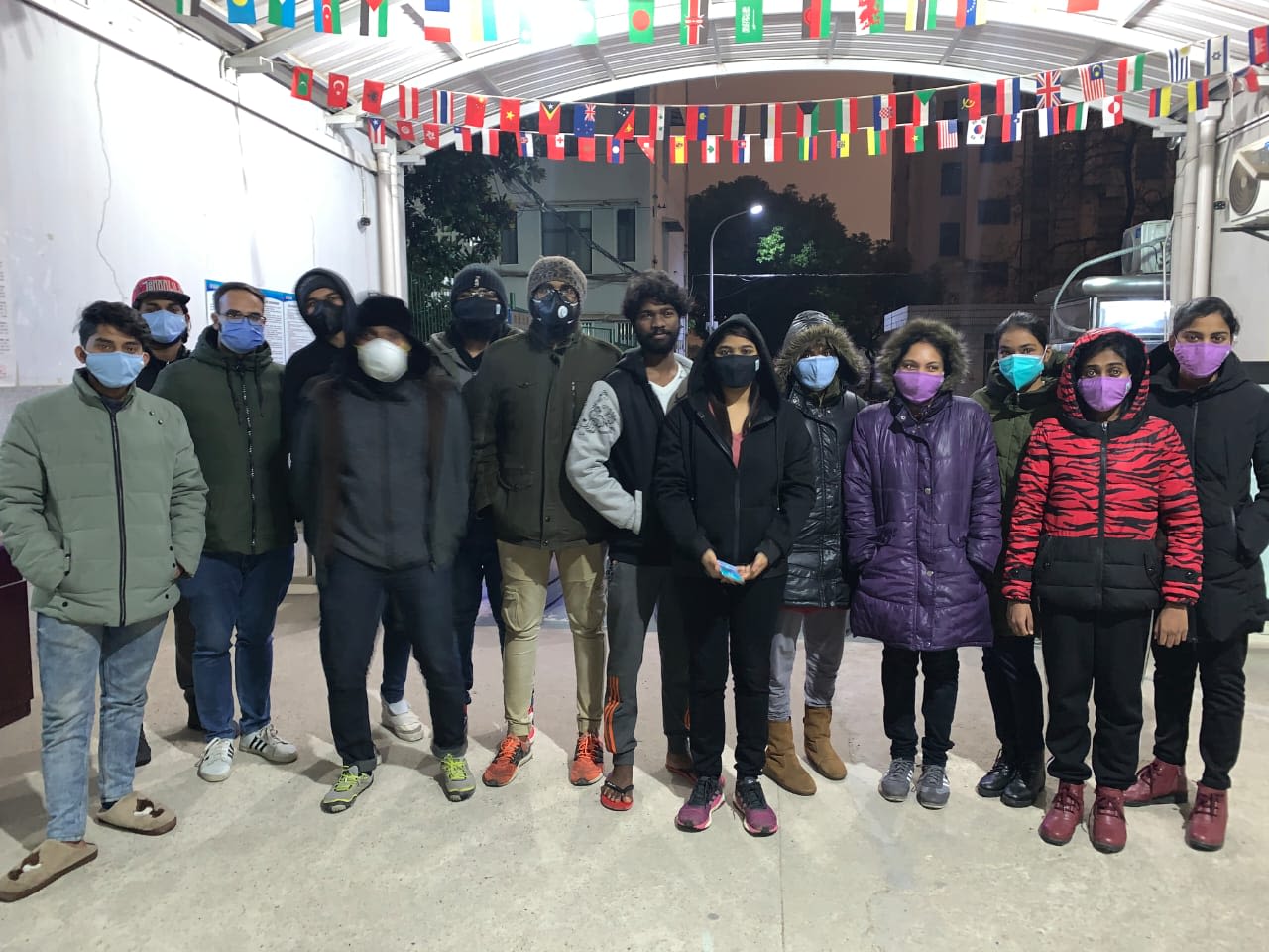 Indian students stand outside the foreign dormitory entrance at Wuhan Medical University.