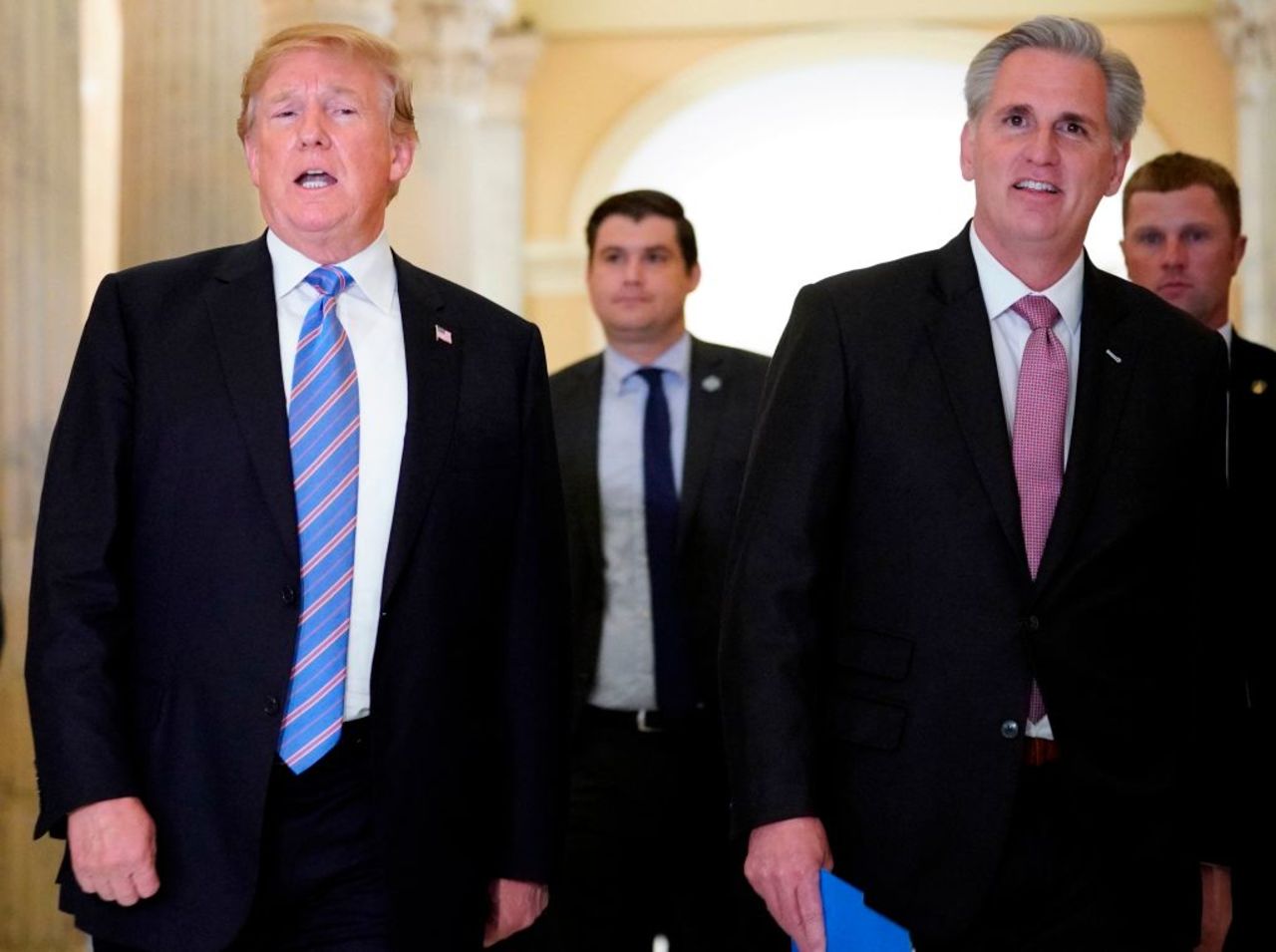 President Donald Trump (L) walks next to US House Majority Leader Kevin McCarthy (R-CA) after a meeting at the US Capitol with the House Republican Conference in Washington, DC on June 19, 2018.