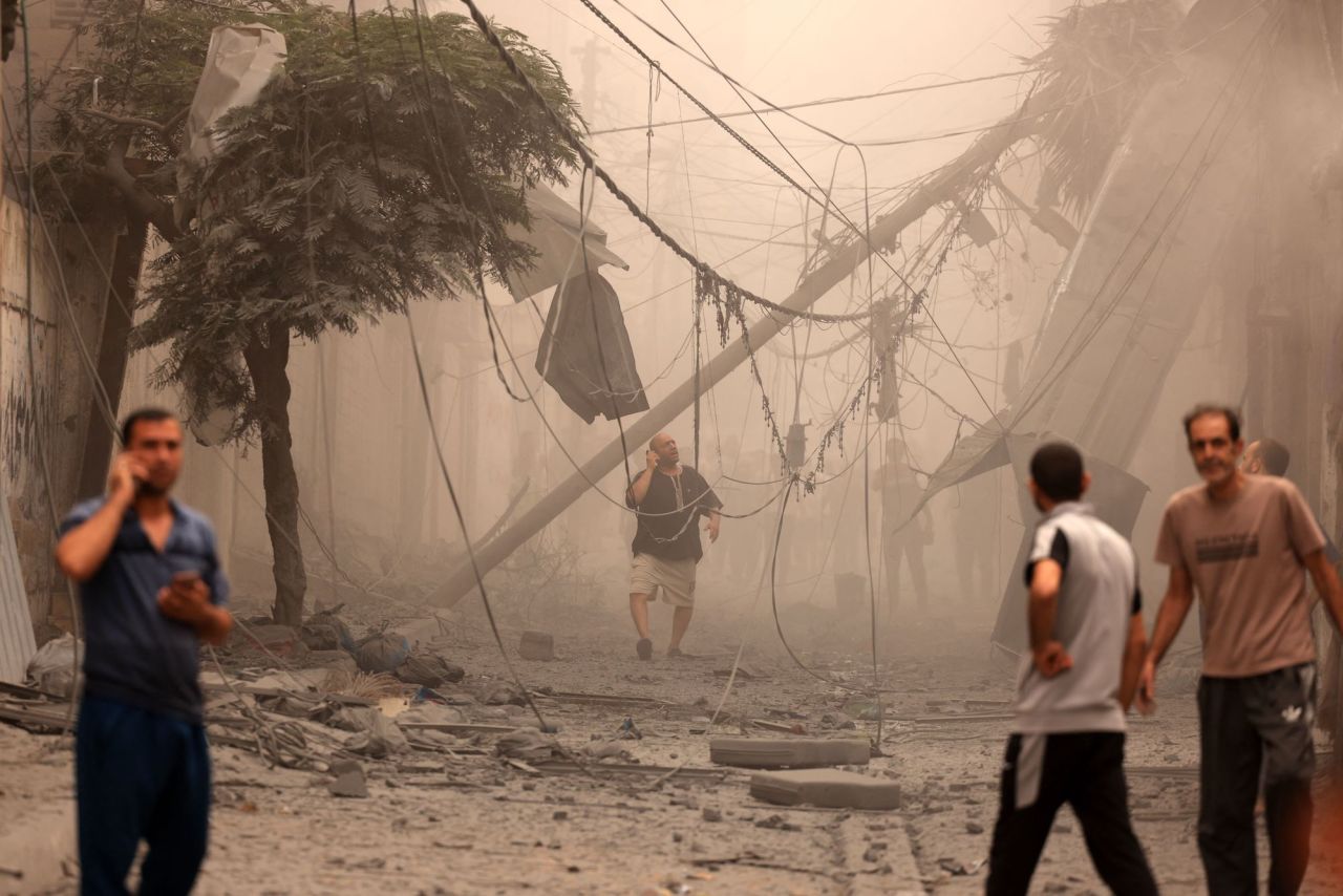 Palestinians inspect the destruction in a neighborhood heavily damaged by Israeli airstrikes in Gaza City's Shati refugee camp early on Monday.