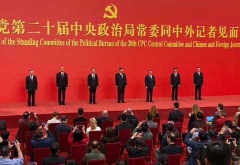New members of the Politburo Standing Committee, from left, Li Xi, Cai Qi, Zhao Leji, Xi Jinping, Li Qiang, Wang Huning, and Ding Xuexiang are introduced at the Great Hall of the People in Beijing on Sunday.