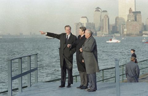US President-elect George H.W. Bush points out sights for Gorbachev while Reagan looks on, as they overlook New York Harbor from Governors Island in 1988.