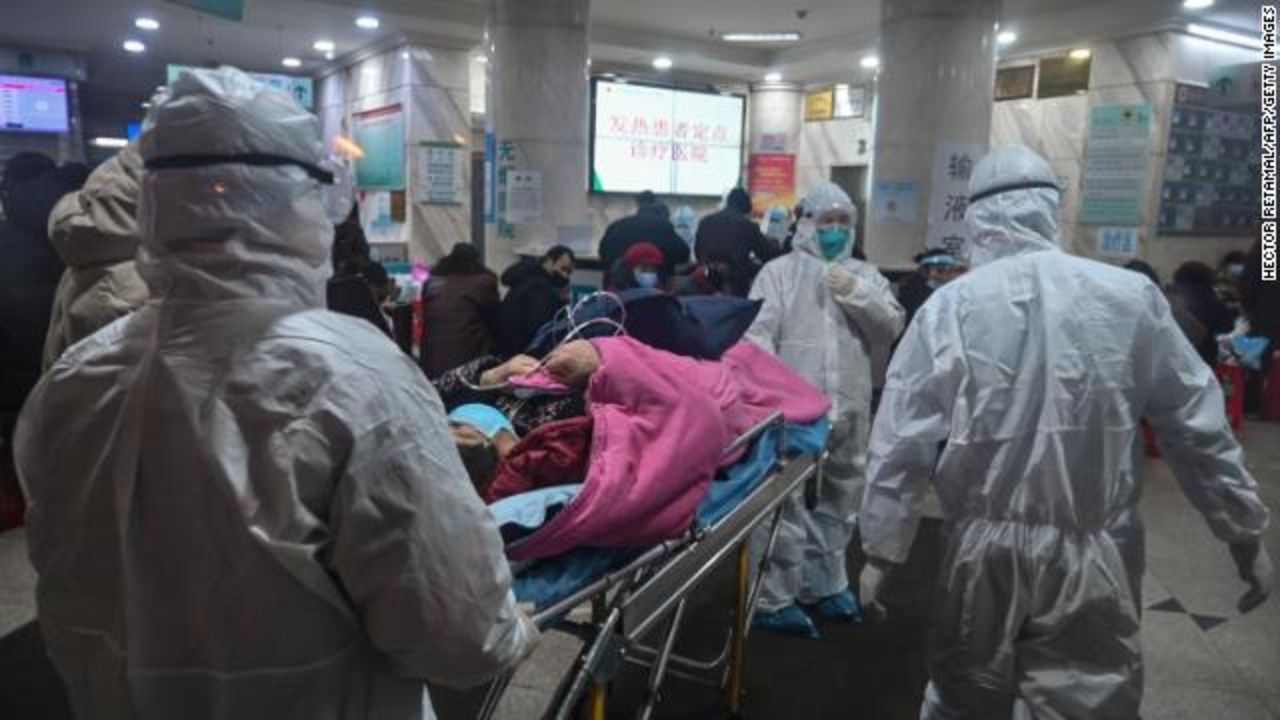  Medical staff arrive with a patient at the Wuhan Red Cross Hospital in Wuhan. 