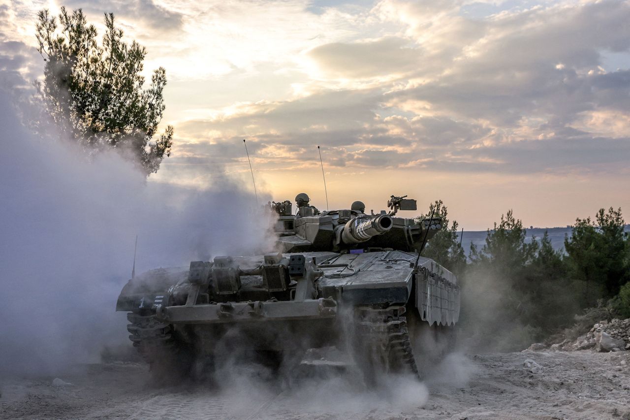 An Israeli army battle tank moves at a position in the upper Galilee region of northern Israel near the border with Lebanon on November 1.