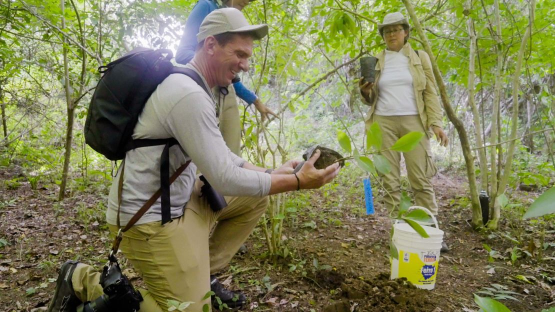 Bill plants a tree on behalf of his children, River and Olivia.