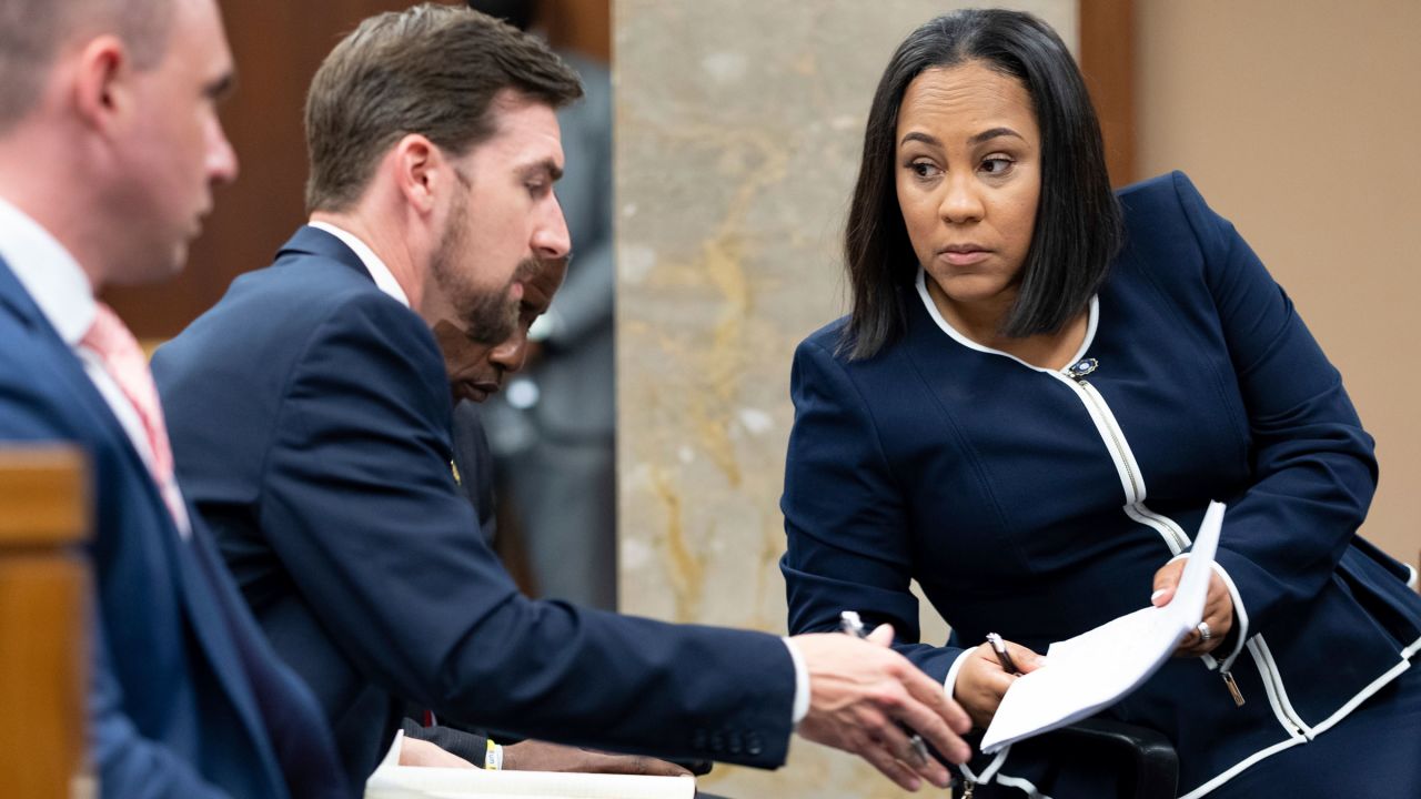 Fulton County District Attorney Fani Willis, right, talks with a member of her team last year during proceedings to seat a special purpose grand jury.