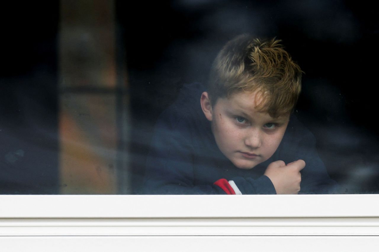 Dexter Britton looks out through a window in Lisbon Falls, Maine, on Thursday. The Lisbon area has been under a shelter in place order since Wednesday night.