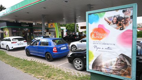 Cars wait in line at a gas station in Budapest, Hungary on May 27,  where cars with Hungarian plates may buy fuel at government-capped prices, while cars with foreign number plates pay market prices. 