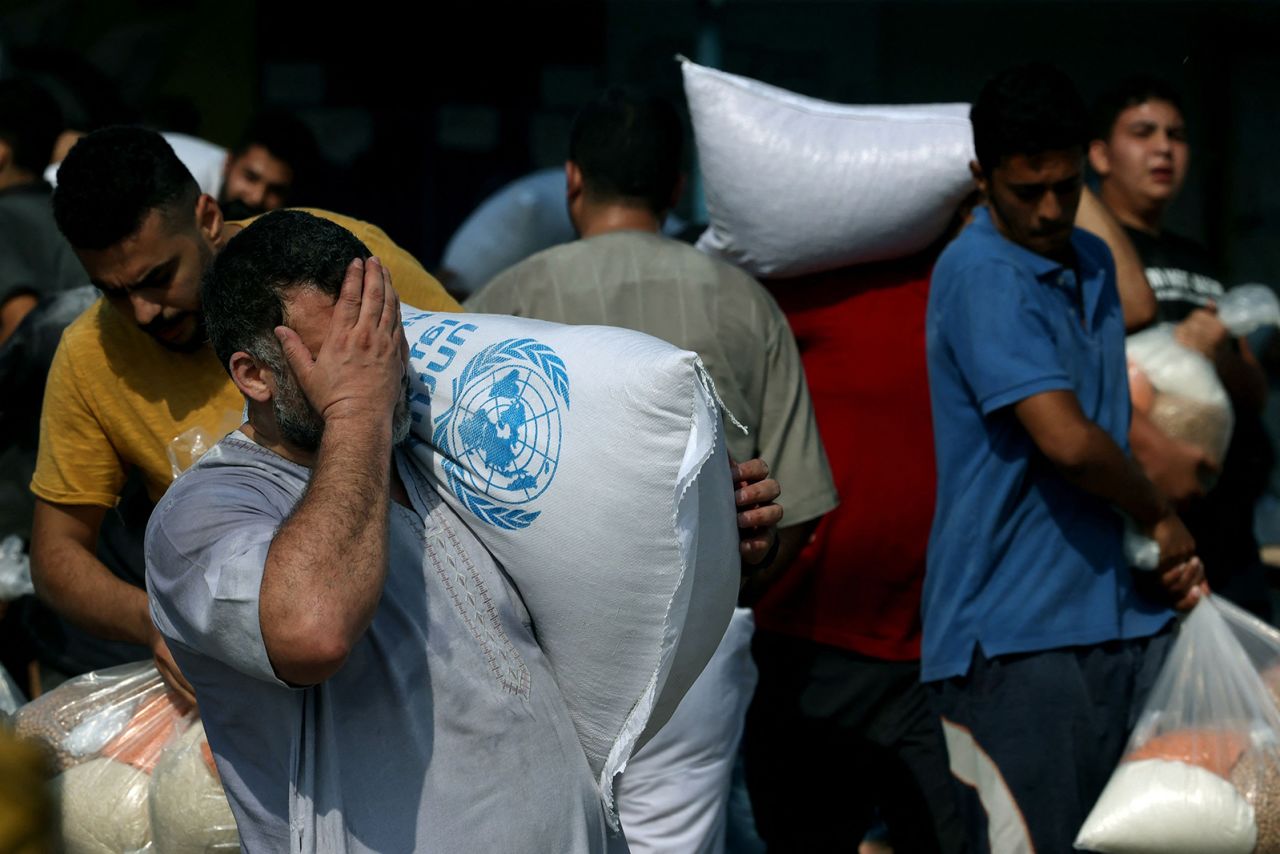 Palestinians storm a UN-run aid supply center in Deir al-Balah, Gaza, on October 28.