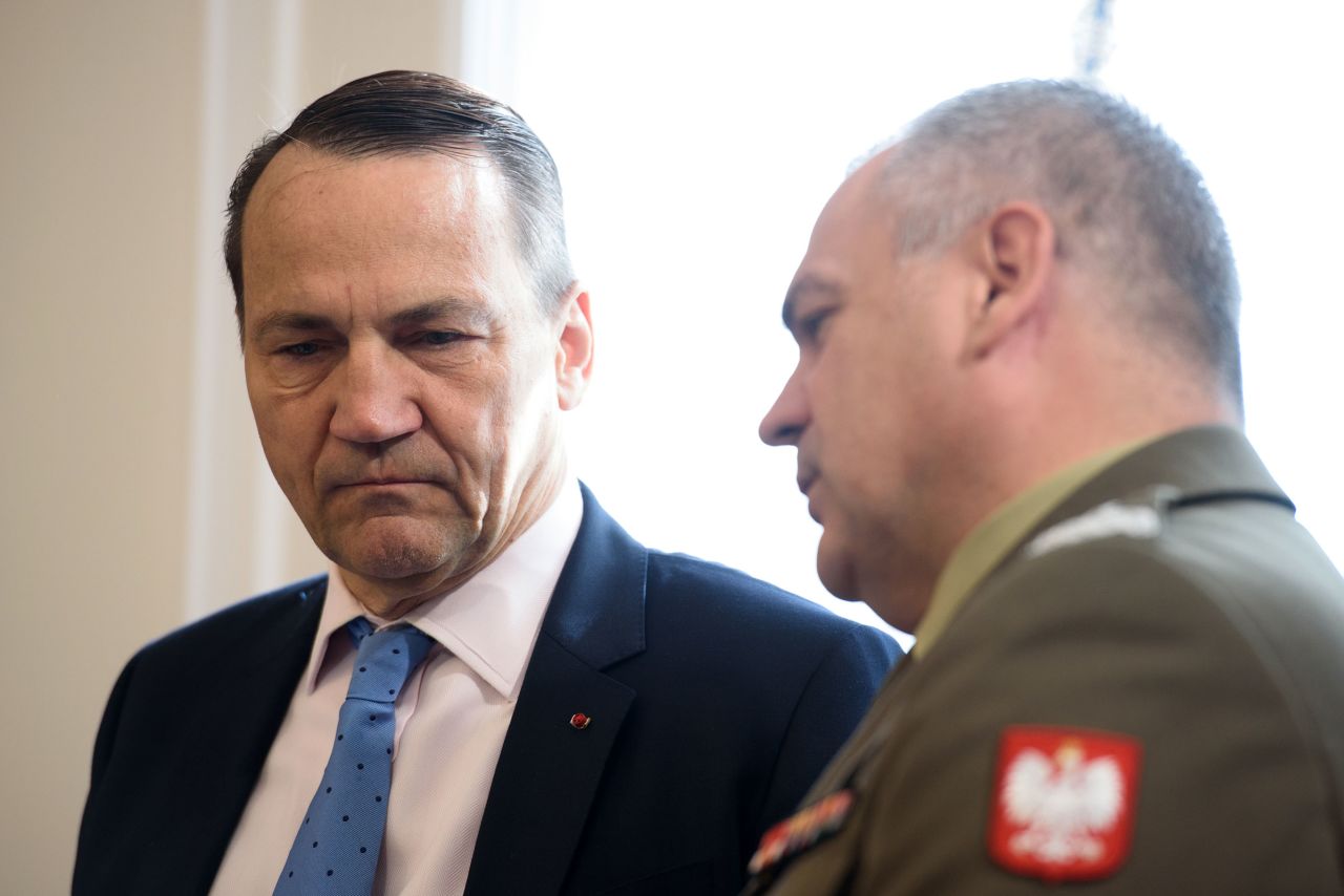 Poland's Foreign Minister Radoslaw Sikorski, left, speaks with the Chief of the General Staff of the Polish Armed Forces Wieslaw Kukula, right, before the National Security Council gathering in Warsaw, Poland, on July 8.