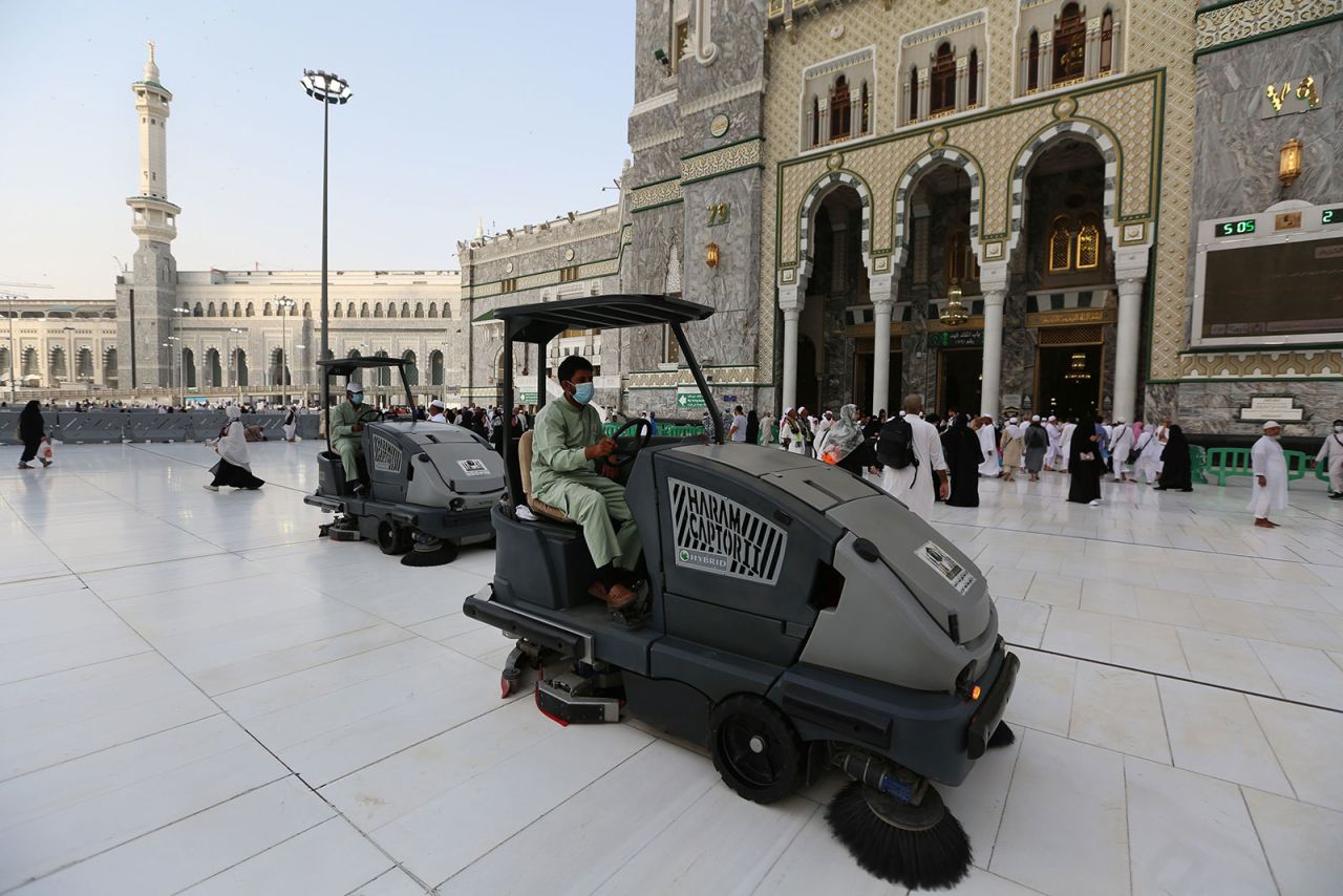 Laborers wearing masks clean the floor of the Grand Mosque in Saudi Arabia's holy city of Mecca on February 28, 2020.