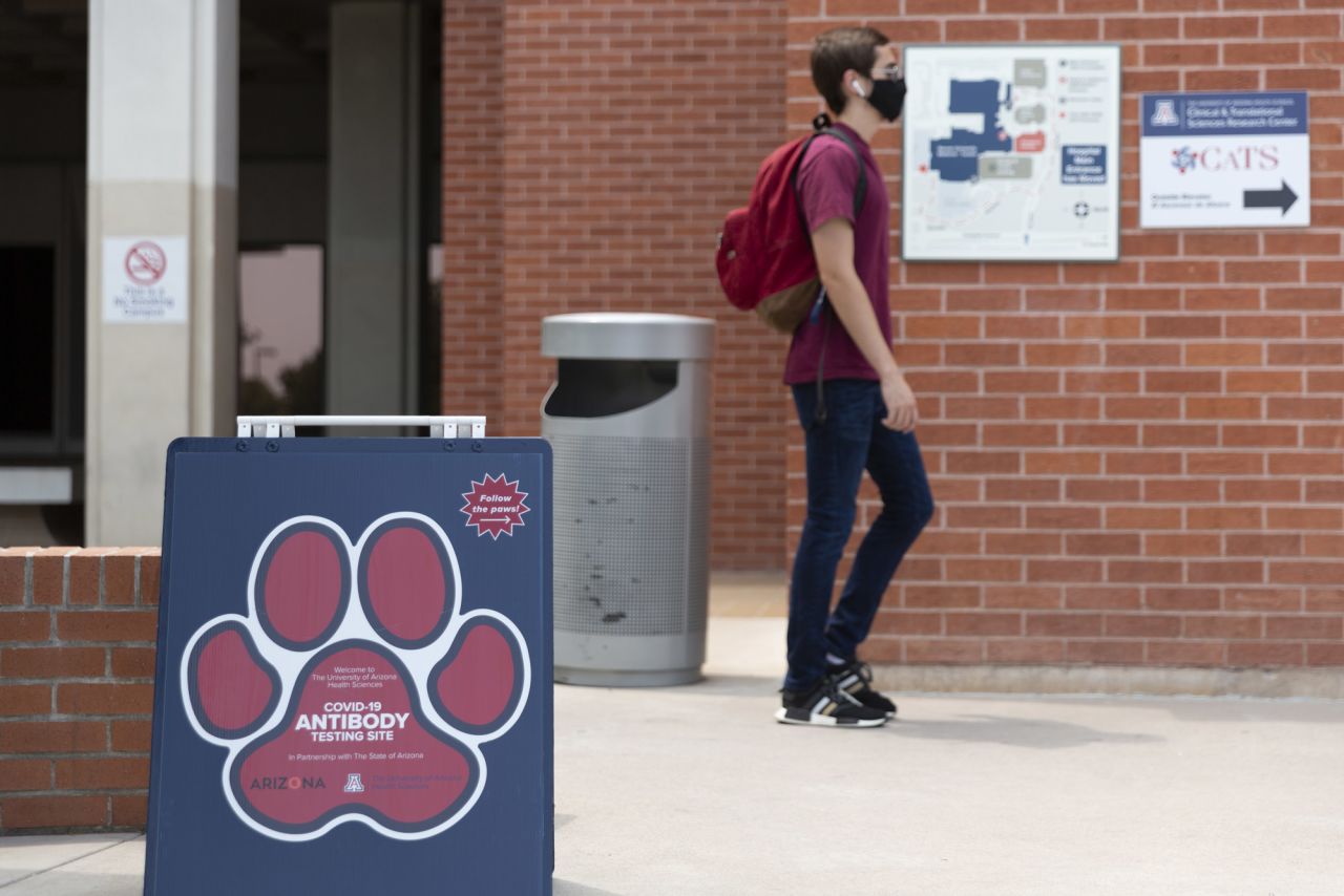 A person passes a Covid-19 antibody testing sign at the University of Arizona in Tucson, Arizona, on August 24. 
