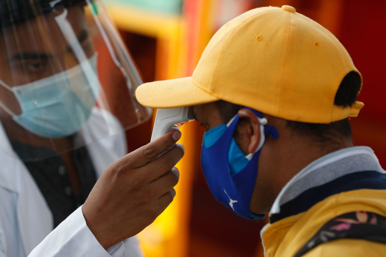 A worker gets his temperature taken prior to being tested for Covid-19 in Mexico City, on Thursday, September 10. 