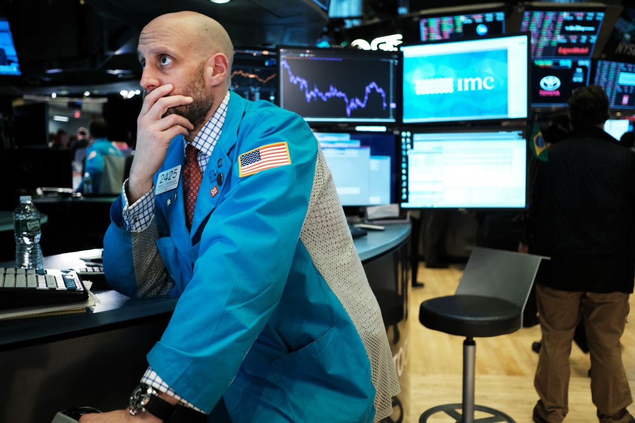 Traders work on the floor of the New York Stock Exchange as stocks fall over global concerns about the economic impact of the coronavirus.?