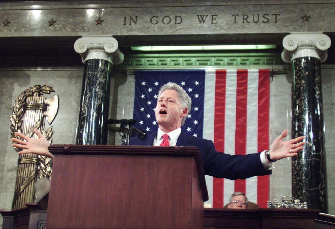 Bill Clinton spreads his arms as he addresses the Congress during his final State of the Union address in Washington, DC, on January 27, 2000.