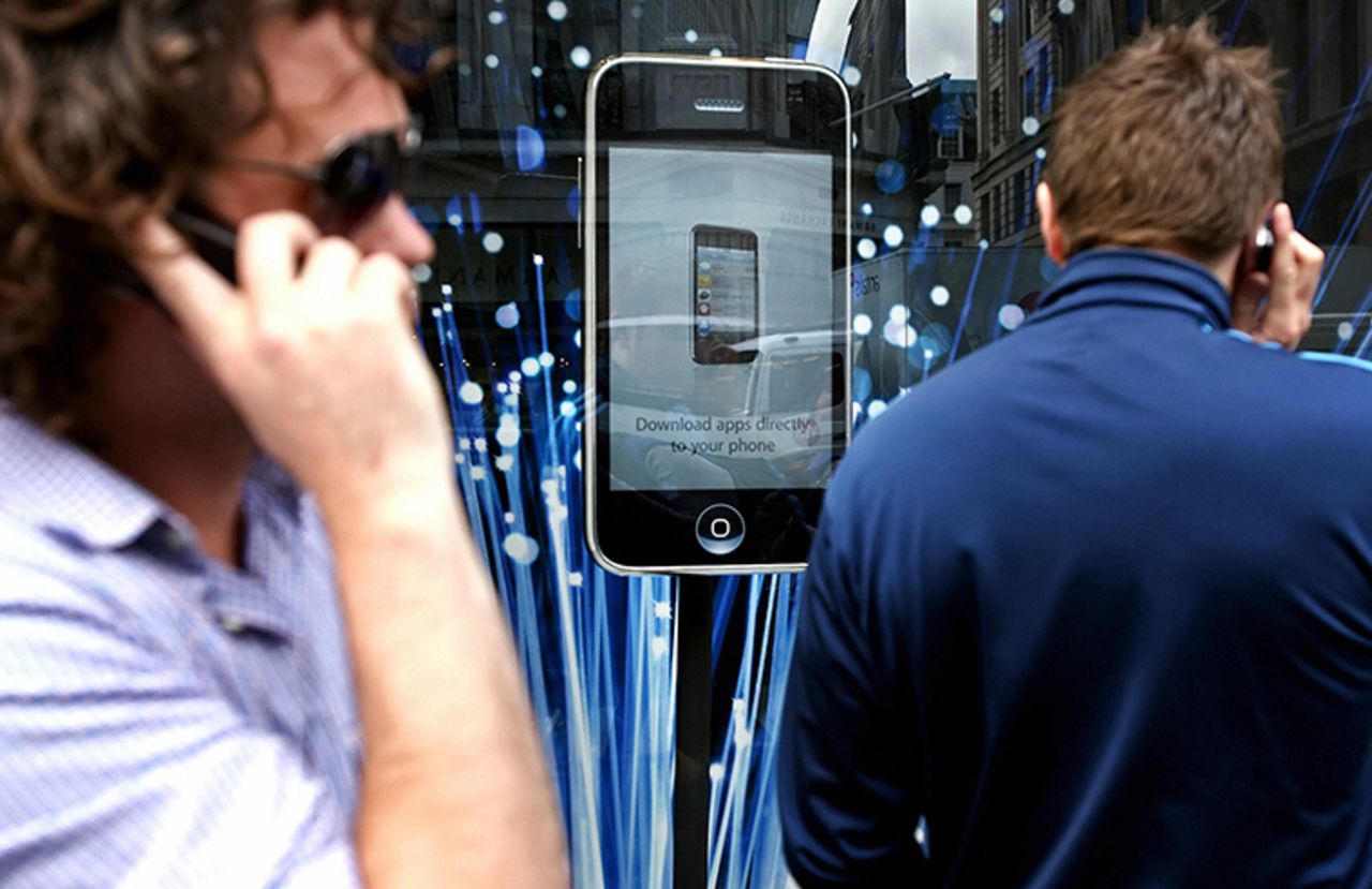 Customers queue outside the Apple Store in London for the launch of the iPhone 3G on July 11, 2008. 